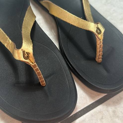 Olukai  Ho'Opio Womens Gold Black Slip On Thong Sandals