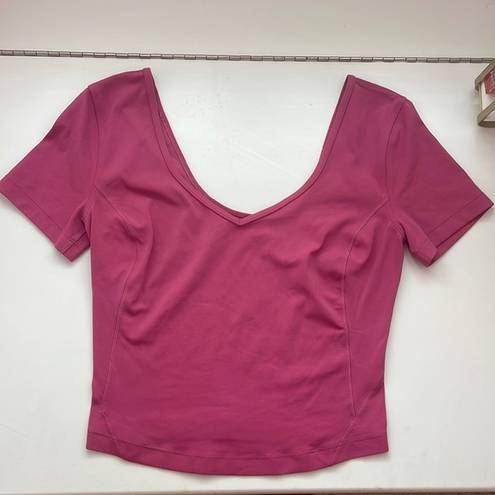 Lululemon This  align t-shirt is in a size 2 and is a dark pink magenta color.