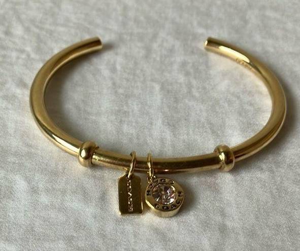 Coach: Gold Tone Charm Braclet- 2 charms- coach tag & rhinestone- open/slide on