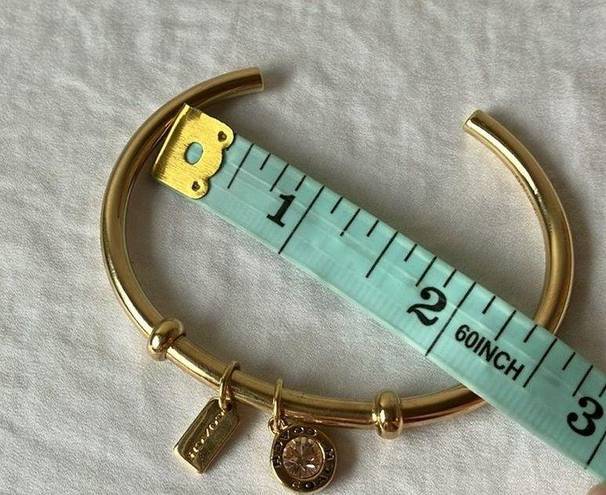 Coach: Gold Tone Charm Braclet- 2 charms- coach tag & rhinestone- open/slide on