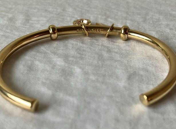 Coach: Gold Tone Charm Braclet- 2 charms- coach tag & rhinestone- open/slide on