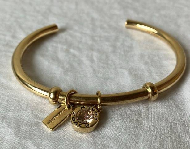 Coach: Gold Tone Charm Braclet- 2 charms- coach tag & rhinestone- open/slide on