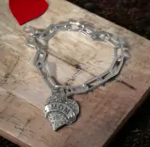 Criss Cross Ponytail Hat featuring a camo print and a Mom Heart Trucker Band.