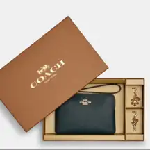 Authentic COACH Leather zip wristlet & 2 charms set