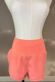 Pink Athletic Shorts With Tight Waistline And Flowy Bottom