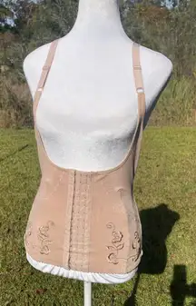 Corset body shaper in beige or nude with adjustable straps & hook/eye closure.