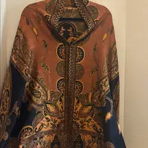 JNS BRAND…SHAWL LIKE PONCHO OVER THE HEAD…SHORTER IN THE BACK LONGER IN FRONT