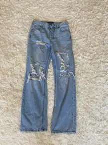 Ripped baggy 90s light wash high rise jeans. 