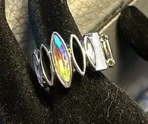 Beautiful stretch ring. The stones are glass, and two of the designs are hollow.