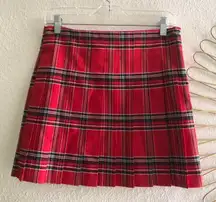 Red plaid pleated mini skirt with black and white stripes and pleats