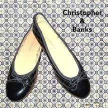 Christopher & Banks black patten leather quilted look design with tie on front