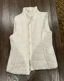 Stay warm and stylish with this sleek white puffer vest. Perfect for layering in cooler weather.