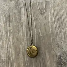 Free people locket necklace “by the light of the magic hour”
