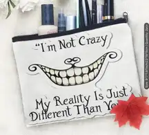 Afun attitude makeup bag with the words "I'm not crazy, my reality is different