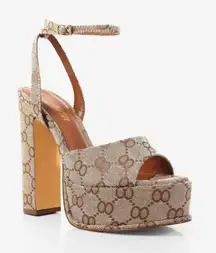 This is a pair of Josy-6 by Liliana monogram platform heels with an ankle strap. 