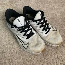 Nike running shoes in white and black with cheetah print