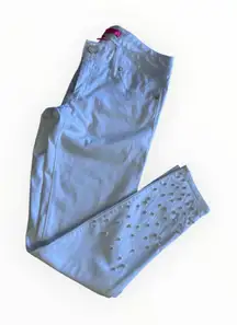 the image is a pair of Lilly Pulitzer Worth Skinny Pants in white with pearl embellishments. Product Details Style: Worth Skinny Pants  Color: White, also referred to as Resort White  Features: The pants have pearl embellishments along the bottom of the