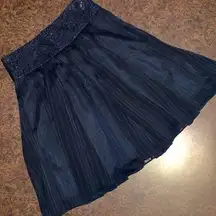 Black knee length skirt with sequin waistband and sheer overlay - size small