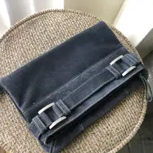 Faux suede fold over clutch purse bag with wrist strap and top zip, silver accents.