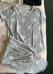 Soft gray pajama set with pink star pattern. Short-sleeve top and matching shorts. Comfortable and stylish.