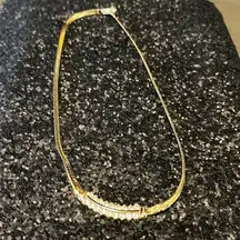 Gold serpentine necklace with Diamond detail. Double row of crystals.