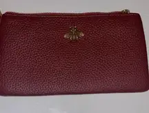 RED PEBBLED LEATHER WRISTLET WITH BRASS BEE ADORNMENT WITH TAN WRISTLET STRAP