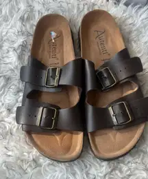 ☀️ Altenti Leather Cork Sandals – Size 9 (Women’s) Made in Spain 🇪🇸  Slide into comfort and timeless style with these Altenti leather sandals. Designed with double adjustable buckles and a supportive cork footbed, they’re perfect for all-day wear — from errands to vacation strolls.  ✨ Women’s size 9 – true to size ✨ Genuine leather upper with bronze buckles ✨ Soft cork footbed for comfort & support ✨ Minimal wear – great condition ✨ Made in Spain  