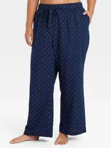 Auden Polka Flannel Drawstring Pajamas Pants w/Pockets Size XXL NWT  The Auden Polka Flannel Drawstring Pajamas Pants in size XXL are a comfortable and stylish choice for plus-size women. Made of soft flannel fabric, these navy polka dot pajama pants feature a drawstring closure and convenient pockets. Perfect for a cozy night's sleep, these pants offer a blend of fashion and function in a fun polka dot design.