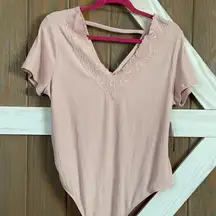 Pink bodysuit. V-neck with lack. V-back with fabric across. Size XXXL. NWT.
