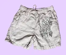 Cream linen shorts with black screenprinted floral print on one side 🔥