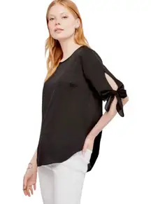 Ann Taylor black tie-sleeve blouse -SP  Gently used and in very good condition other than one tiny snag on left sleeve as circled. Size petite small.  black polyester blouse with bow tie sleeves. $80 retail.