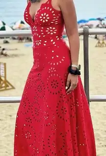 Stand out in this vibrant red maxi dress. Features stylish cutout patterns. Perfect for beach outings or summer events.