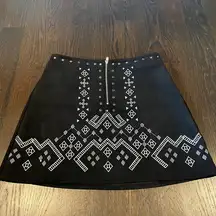 Black faux suede mini skirt with white designs