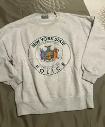 Comfortable gray crewneck with New York State Police design. Perfect for casual wear.