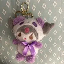 Hello Kitty Kuromi Key Chain. Purple, white and gray in color.