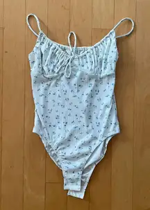 white and blue floral bodysuit