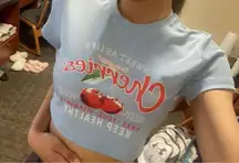 Light blue/baby blue women’s graphic crop top with “cherries” writing.