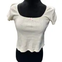 Just Polly cropped white shirt with bow pattern throughout and pink bow‎