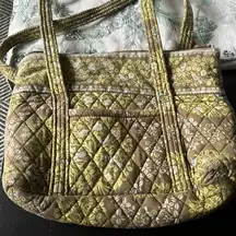 purse. Green with birds.  Used. Two little tiny holes on bottom.