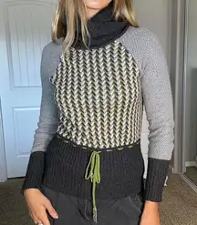 Grey pink and green knit sweater with a cowl neck and tie waist