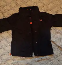 black Hollister All-Weather Jacket with orange accents and a faux fur or fleece lining. 