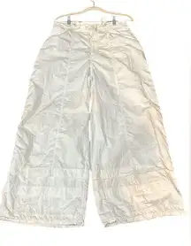 FP Movement Large White parachute pants with elastic waist and drawstring.