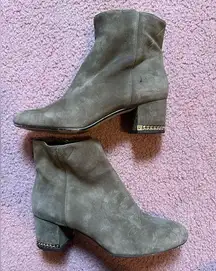 Michael Kors Sabrina leather ankle boot with gold tone heel chain.