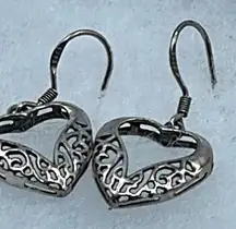Sterling silver cut out heart dangle earrings.