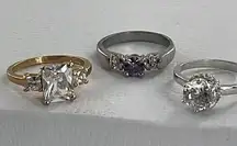 Three costume jewelry size 10 rings. All different colors and styles.