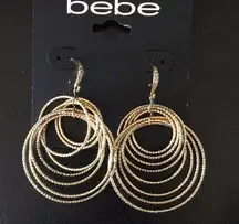 bebe multi Gold rings & Crystal stud earrings