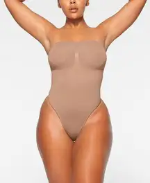 SKIMS  Seamless Sculpt Strapless Thong Bodysuit in Sienna