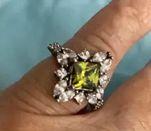 Peridot cubic zirconia rhodium plated ring. Size 8. Clear crystals around ring.