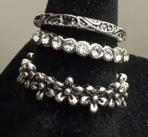 Rings - set of 3 stacking band rings - silver tone stainless steel - faux diamonds. New!  Never worn.   Daisy band 8.25 Glass stone band 6/6.25 Etched band 5.25
