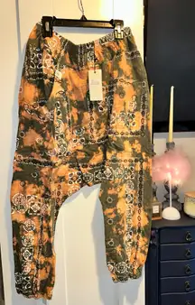 NWT FROM HERE AND BEYOND PANTS BLEACHED OLIVE BANDANA Size:S/M  The NWT Jaded Gypsy Women's Harem Jogger Pants are a stylish and comfortable option for various occasions such as travel, weddings, or casual wear. Featuring a unique Bandana Tiedye pattern, these pants are made from cotton with a relaxed fit and tapered leg style. The high-rise design adds a chic touch, while the elastic waist and pockets provide comfort and functionality. Perfect for those who love a beachy, hippie, or bohemian style, these pants are machine washable for easy care!   No refunds or cancellations